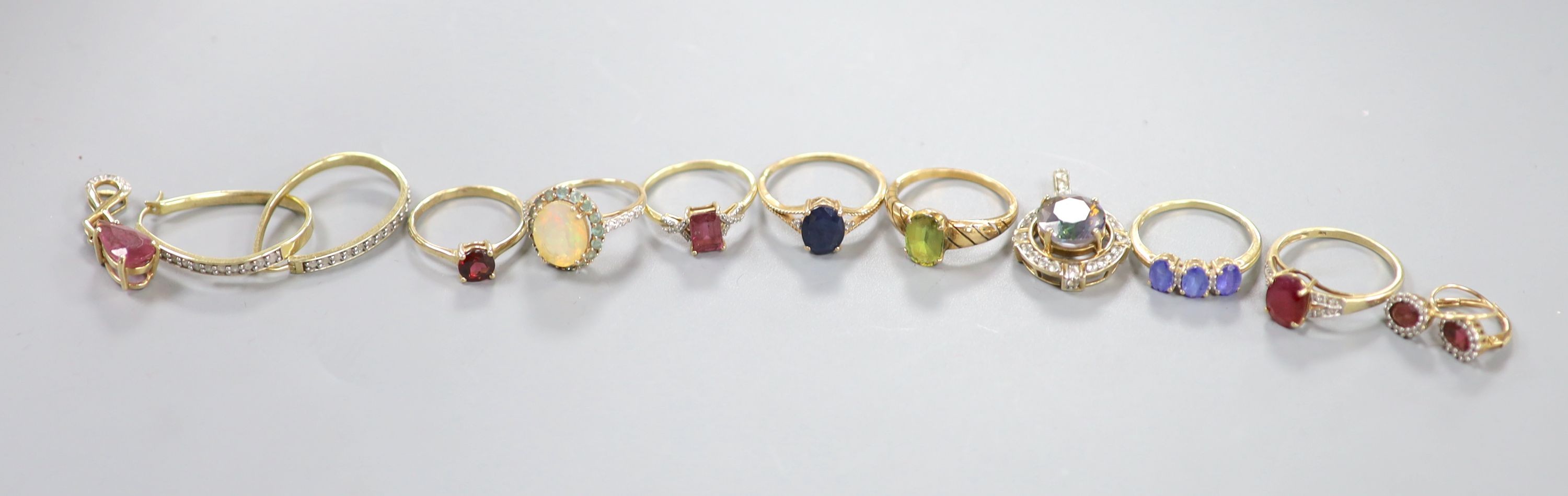 Six assorted modern 9ct gold and gem set dress rings, a pair of 9ct and gem set earrings and two 9ct gold and gem set pendants, gross weight 22.2 grams, a yellow metal and olivine? ring, gross 3.7 grams and a pair of 925